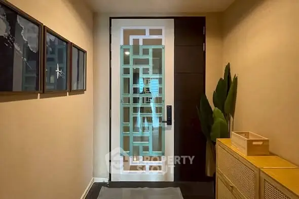Stylish modern entrance with decorative glass door and elegant hallway decor.