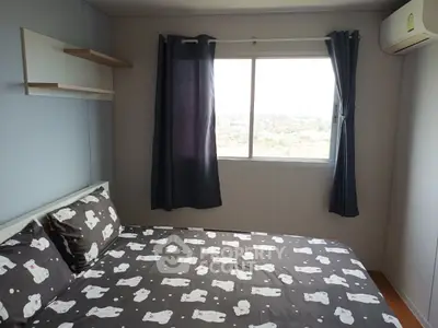 Cozy bedroom with large window and stylish bedding in modern apartment.