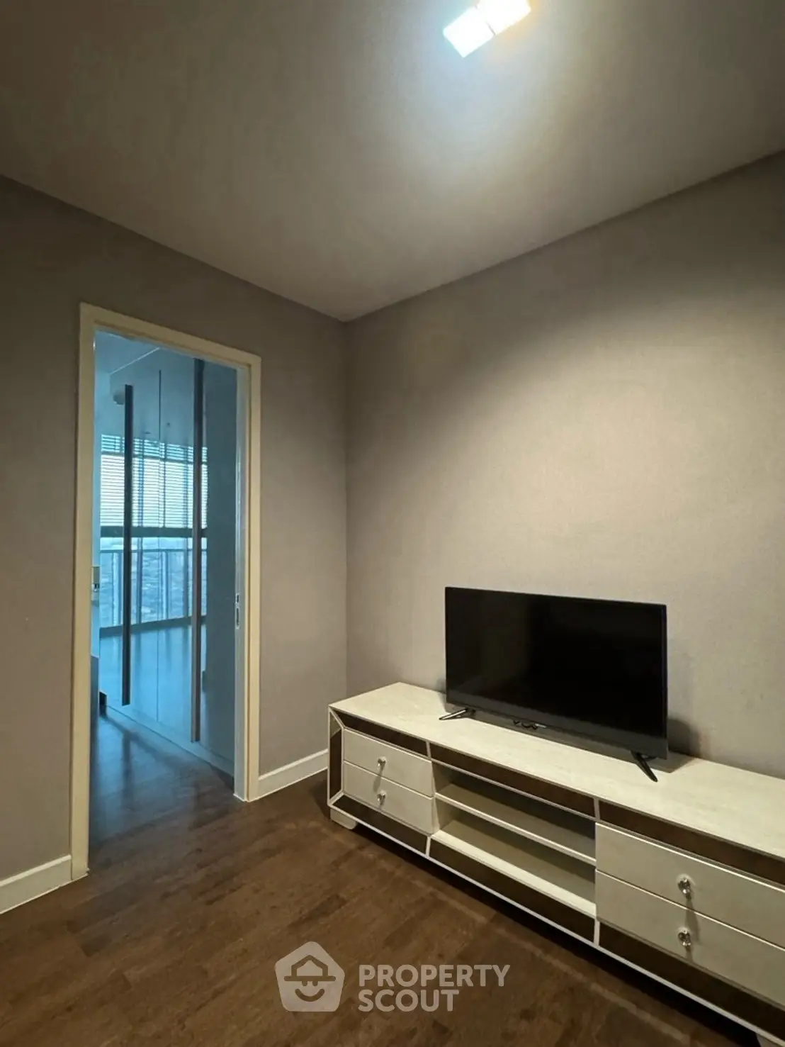 Modern living room with sleek TV stand and wooden flooring