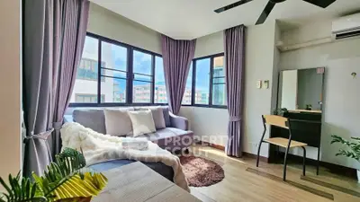 Bright and cozy living room with modern decor and large windows.