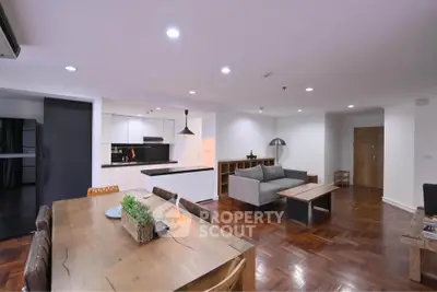Spacious open-plan living and dining area with modern kitchen and stylish decor.