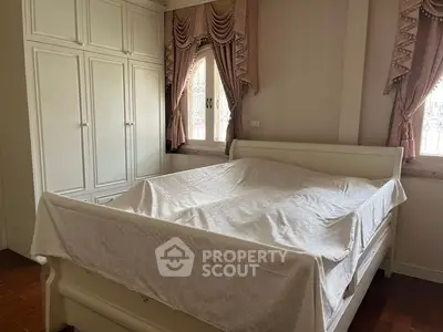 Elegant bedroom with classic white furniture and stylish curtains