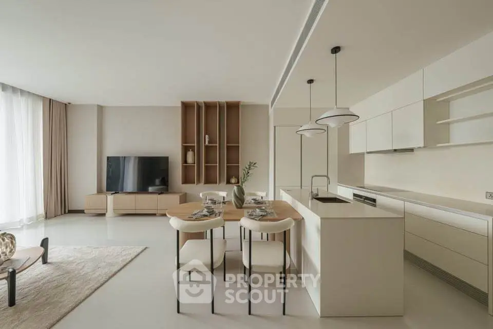 Modern open-layout living room and kitchen with sleek design and neutral tones.