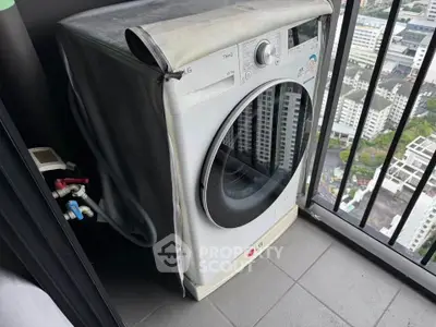 High-rise balcony with washing machine and city view