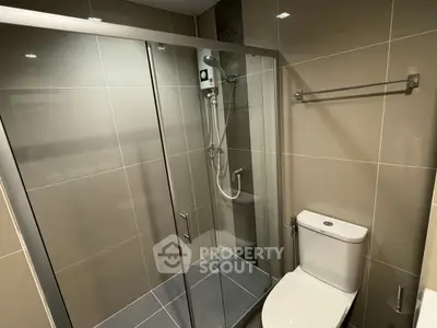 Modern bathroom with glass shower enclosure and sleek fixtures