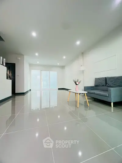 Spacious modern living room with sleek tile flooring and minimalist decor