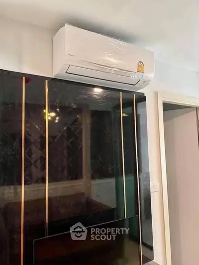 Modern interior with sleek air conditioning unit and stylish wall paneling.