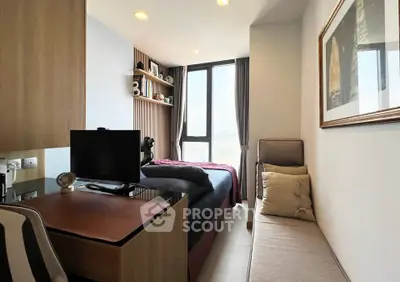 Modern bedroom with study area and large window offering natural light.