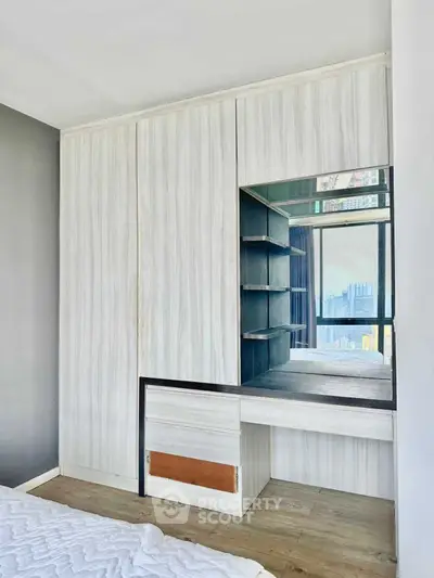 Modern bedroom with built-in wardrobe and city view window