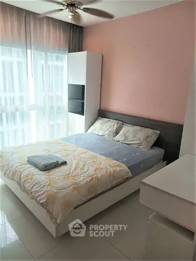 Cozy bedroom with modern decor and large window for natural light