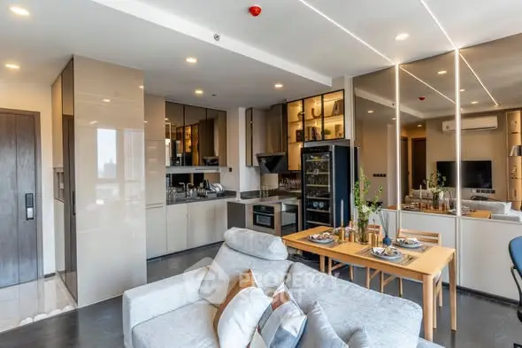 Modern open-plan living room and kitchen with sleek design and dining area.