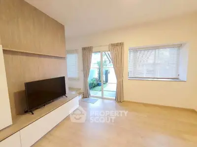 Spacious living room with modern decor and large windows for natural light.