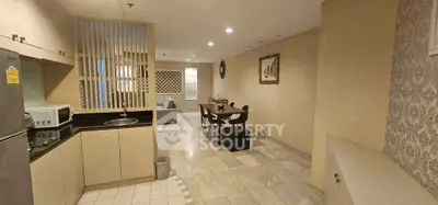 Spacious open-plan living and dining area with modern kitchen in a stylish apartment.