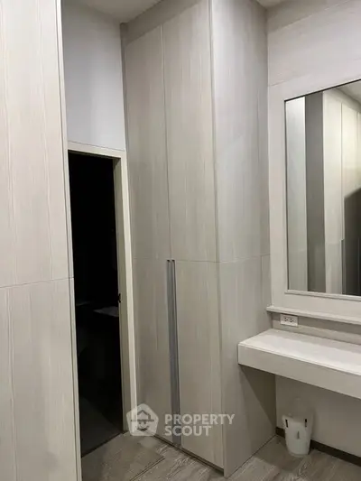 Modern bathroom with sleek cabinetry and large mirror