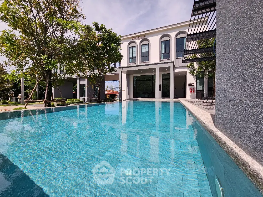Luxurious modern villa with stunning pool and lush garden view