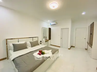 Spacious modern bedroom with elegant decor and cozy ambiance