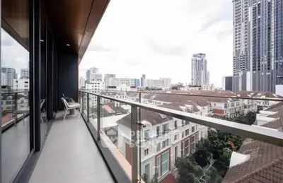 Spacious balcony with stunning cityscape views in modern high-rise building.