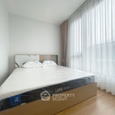 Spacious bedroom with modern design and large window for natural light