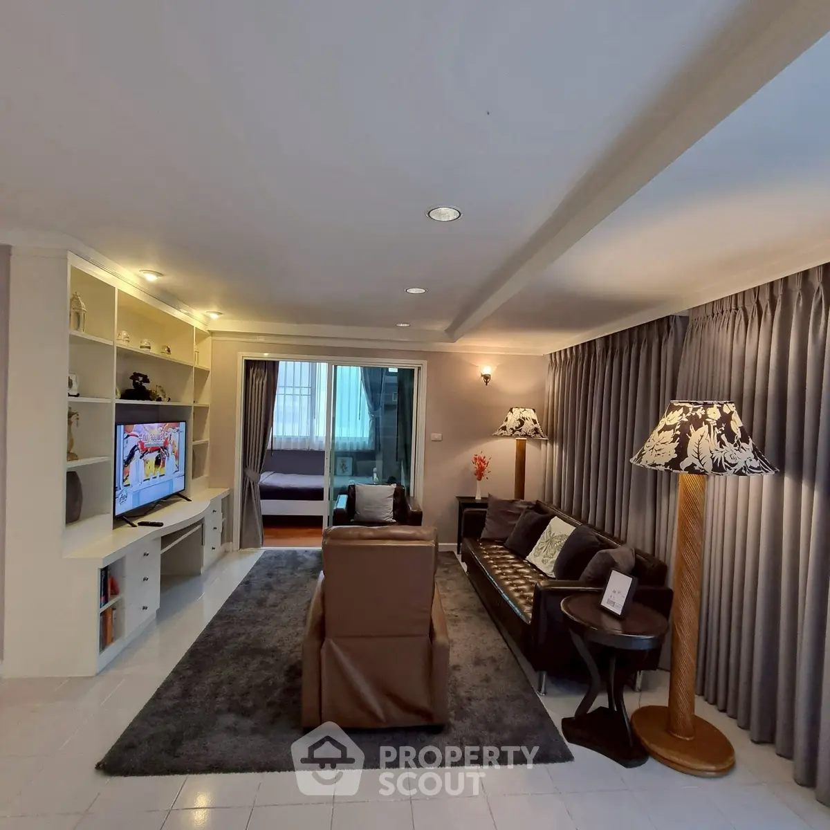 Spacious living room with modern decor and cozy seating area, perfect for relaxation and entertainment.