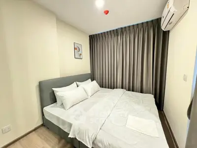 Modern bedroom with cozy bed and elegant curtains in a stylish apartment