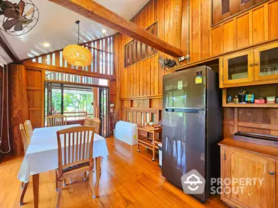 Charming wooden dining area with modern fridge and scenic view