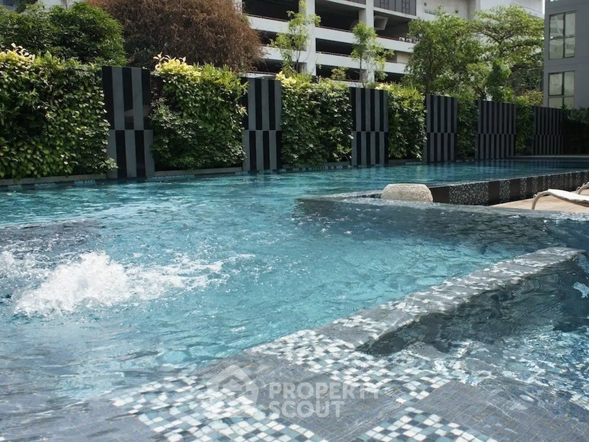 Luxurious residential pool with modern design and lush greenery for ultimate relaxation.