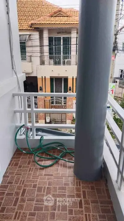 Charming balcony with tiled flooring and city view, perfect for relaxation and outdoor enjoyment.