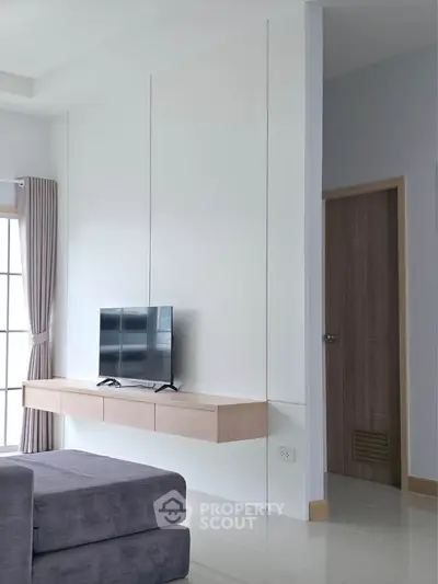 Modern living room with sleek TV setup and stylish decor