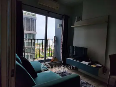 Modern living room with balcony and city view, featuring sleek furniture and natural light.