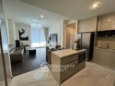 Luxurious open-plan living room and kitchen with modern decor and elegant lighting.