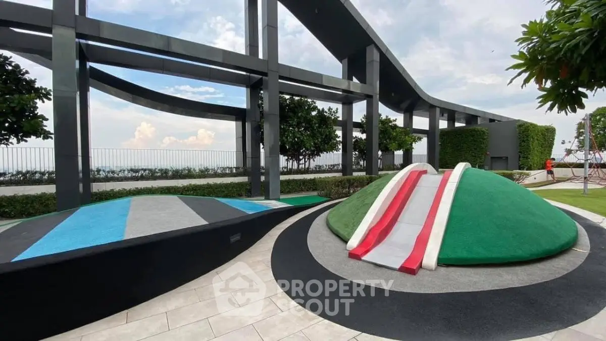 Modern rooftop garden with unique play area and stunning city views.