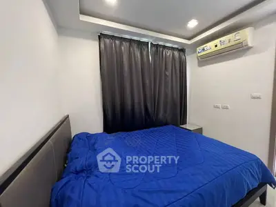 Cozy bedroom with modern air conditioning and elegant blue bedding