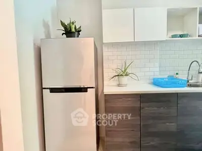 Modern kitchen with sleek fridge and stylish cabinetry