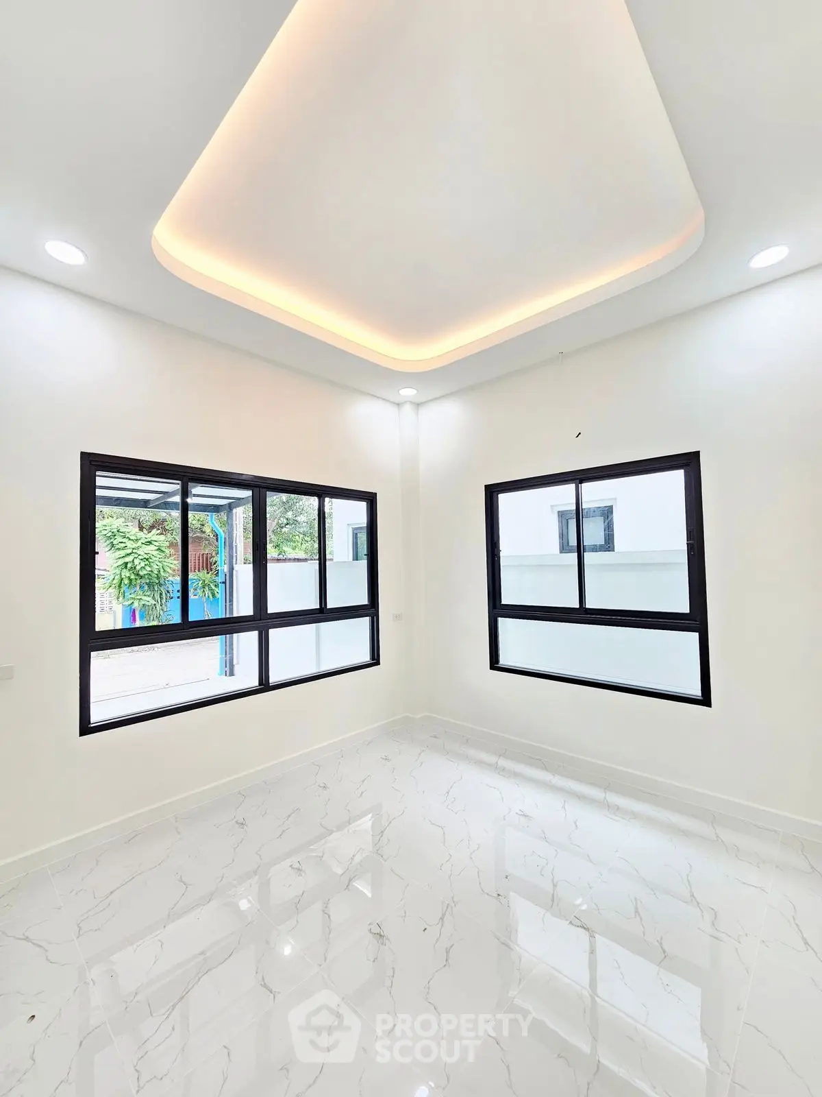 Bright modern room with large windows and elegant ceiling design