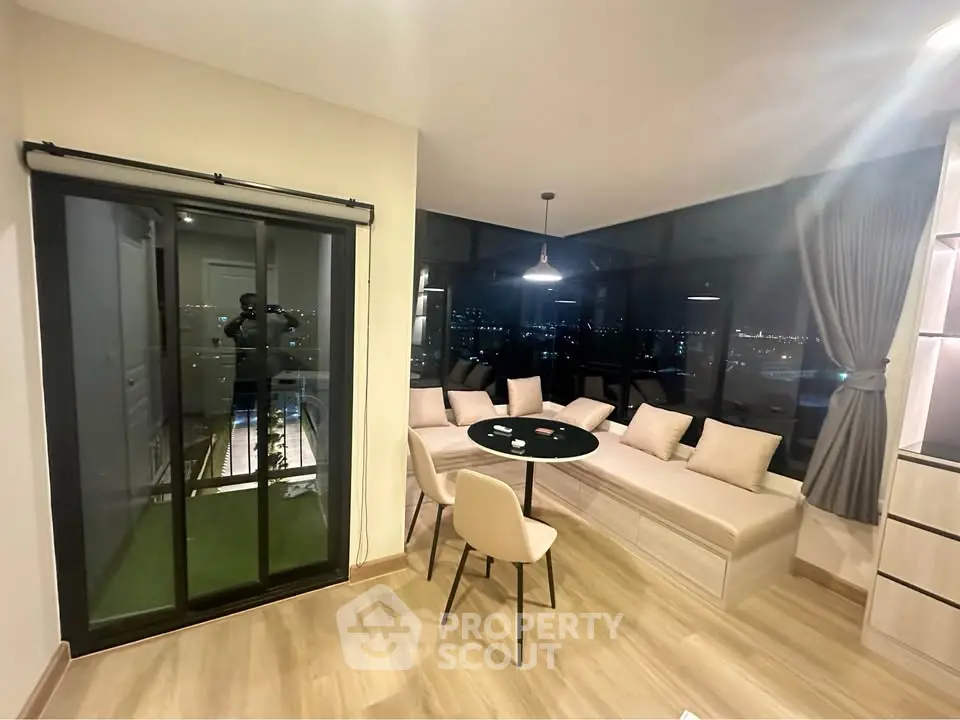 Modern living room with panoramic city view and cozy seating area