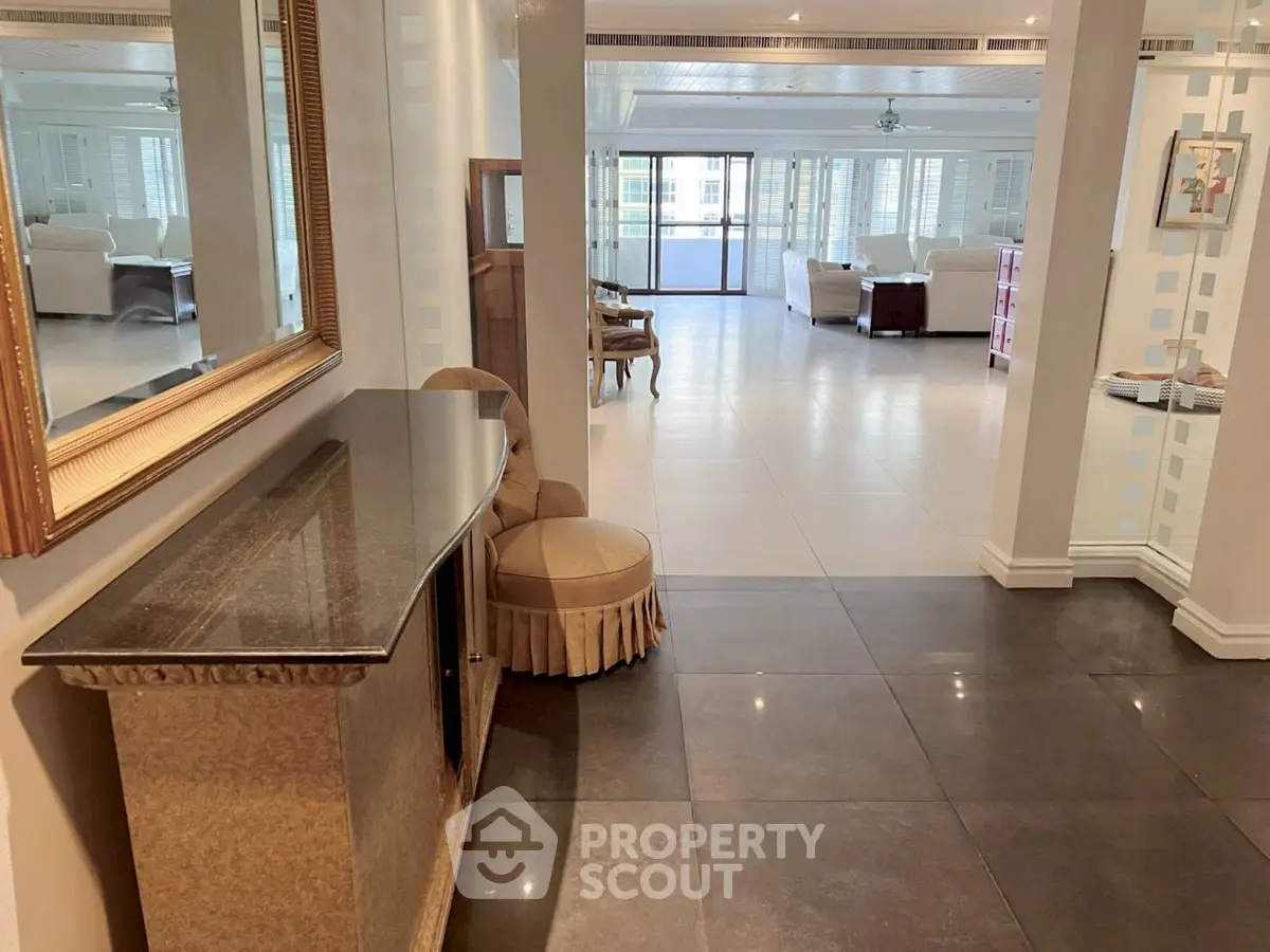 Spacious open-plan living room with elegant decor and ample natural light