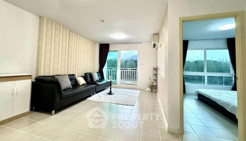 Spacious living room with modern decor and balcony view in a stylish apartment.