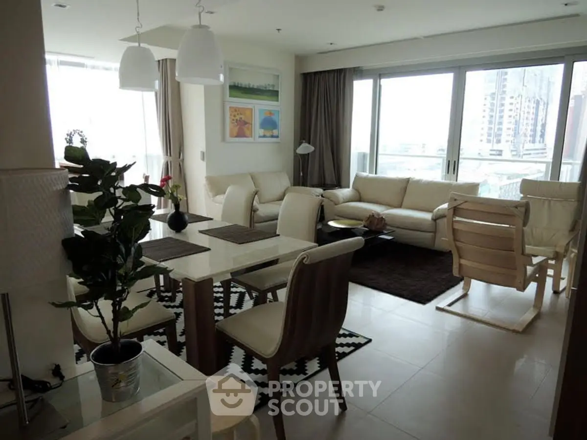 Spacious modern living room with large windows and stylish furniture