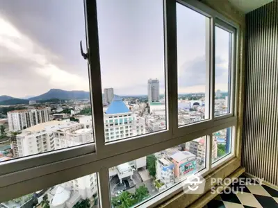 Expansive cityscape view from a high-rise corner unit with large windows, offering a bright and airy living space with potential for personal touches.