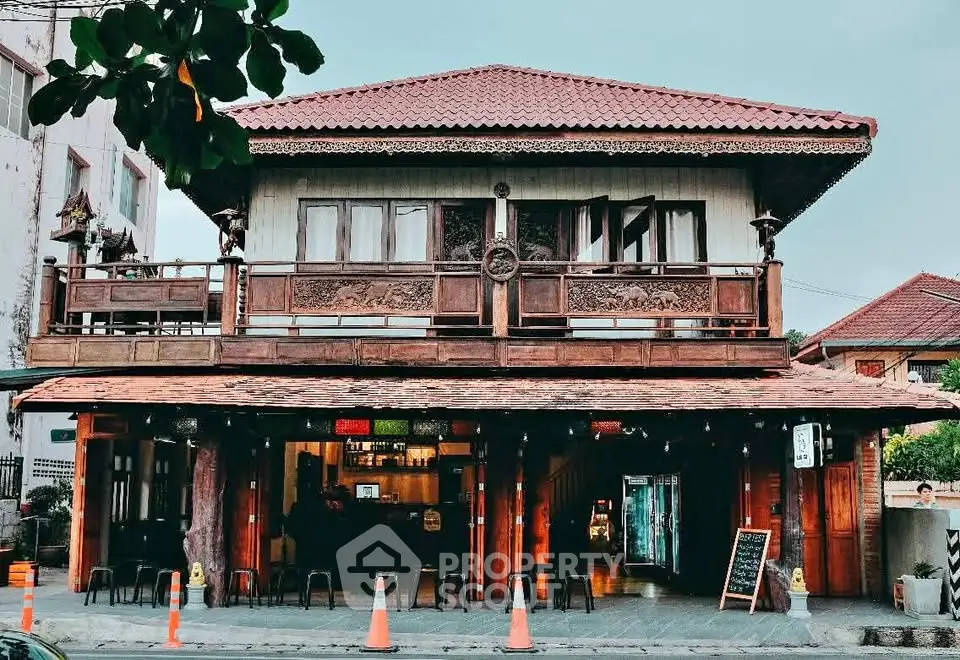 Charming traditional wooden house with intricate balcony design and rustic appeal.