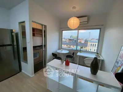 Modern apartment with open kitchen and city view, featuring stylish decor and natural light.