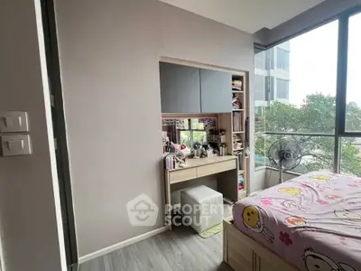 Charming bedroom with large windows and cozy decor, perfect for relaxation and comfort.