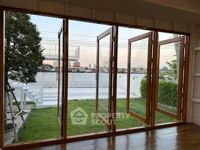 Stunning garden view from modern living room with large glass doors