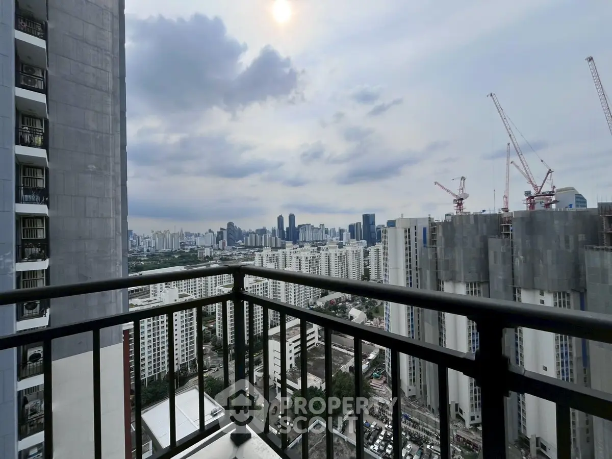 Stunning urban skyline view from high-rise balcony with modern cityscape.