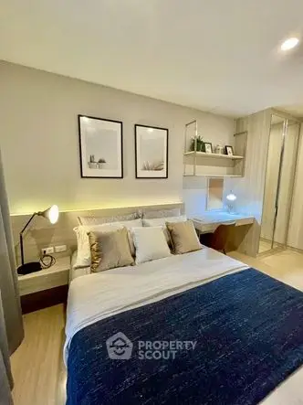Modern bedroom with stylish decor and cozy ambiance, featuring elegant lighting and contemporary furnishings.
