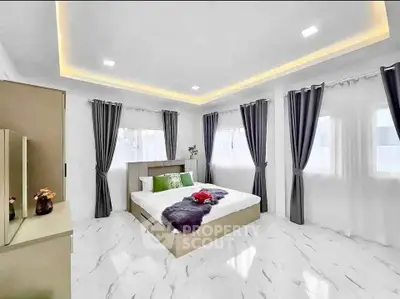Luxurious modern bedroom with elegant decor and ample natural light.