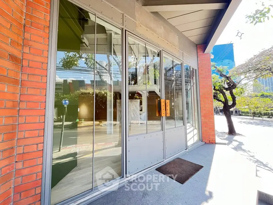 Modern building entrance with glass doors and urban street view