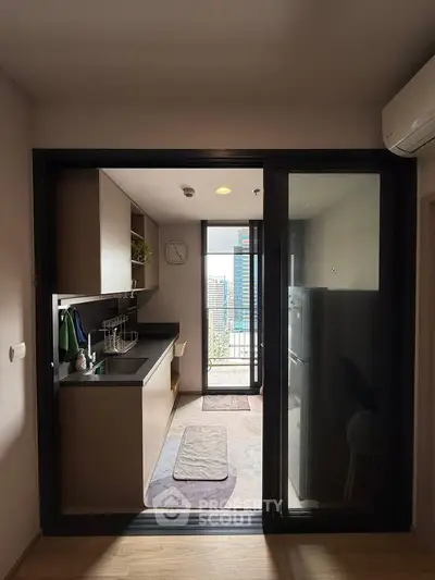 Modern kitchen with sleek design and city view, featuring open layout and contemporary appliances.