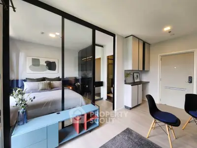 Modern studio apartment with glass partition, stylish decor, and open layout for a cozy living experience.