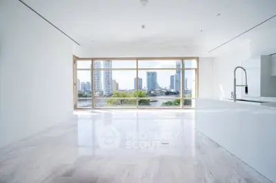 Spacious modern living room with stunning city view and sleek open kitchen design.